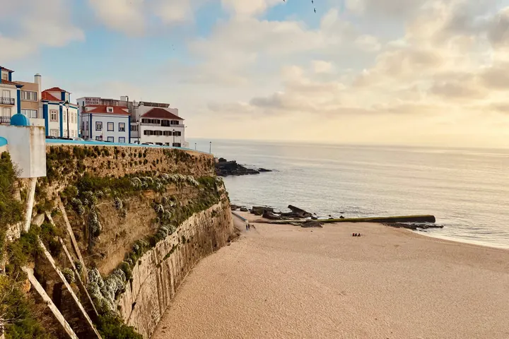 A coastal town and beach in Portugal at sunset