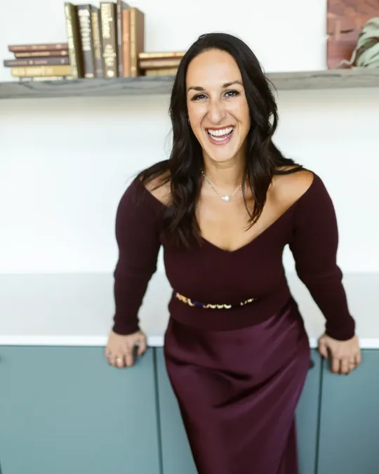 Kristin Darga, executive coach, laughing in her office