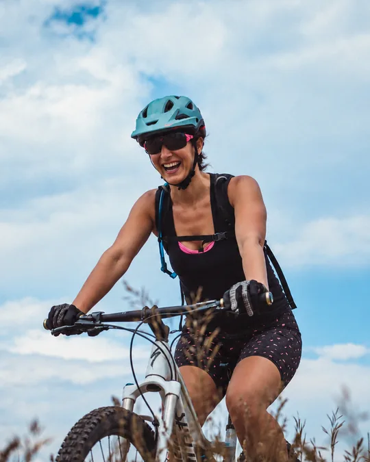 Kristin Darga, executive coach and expedition guide, laughing on a mountain bike ride