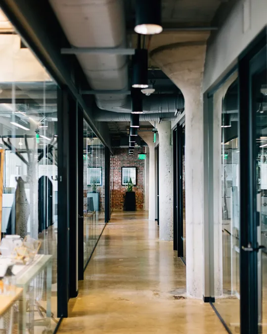 A glass walled office corridor